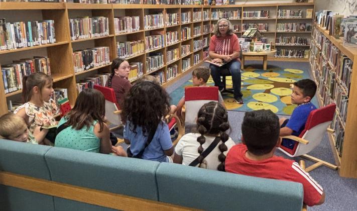 LIBRARY FUN Carol Hester read to children during the Post Public Library Read Aloud program on June 10. | COURTESY PHOTO