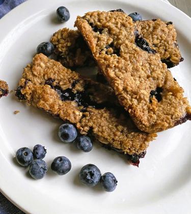 HOMEMADE GRANOLA BARS are a healthier, customizable alternative to store-bought options that often contain unhealthy oils, sugars, and artificial ingredients, despite their marketed image as nutritious snacks; by controlling ingredients like nuts, oats, fruits and natural sweeteners such as maple syrup, you ensure a nourishing, fresh, and tasty treat perfect for breakfast, snacks or lunchboxes, all while avoiding the junk food masquerading as health food in many commercial products. | ANGELINA LARUE PHOTO