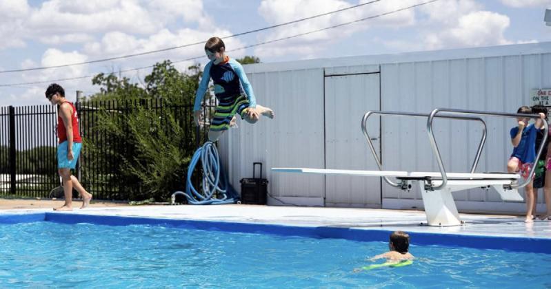 POOL FUN Scouts participating in a dinosaur-themed Scouting America Cub Scout day camp cool off at the Post swimming pool during family day activities. | COURTESY PHOTO