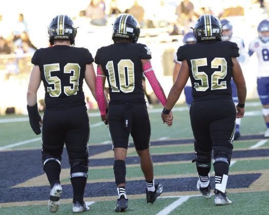Bold Gold Antelope Team Captains, #53 Mason Wright, #10 Jamarion Reed, and #52 Alejandro Rodriguez take to the field for the coin toss.