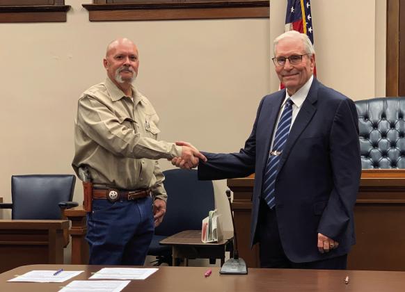 OATH OF OFFICE Newly elected Sheriff Michael Isbell shakes the hand of Garza County Judge Lee Norman after taking the Oath of Office a minute after midnight on Jan. 1, 2025. | ANNA GIBSON PHOTO