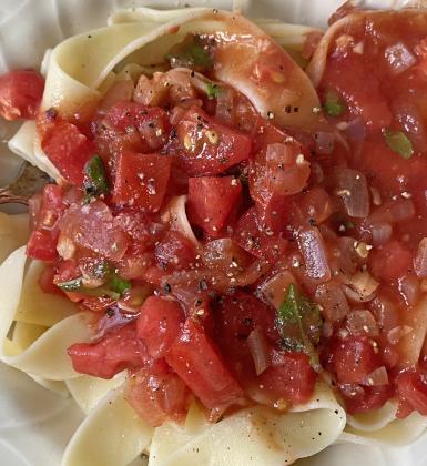 FRESH TOMATO SAUCE WITH PAPPARDELLE has savory tender, wide noodles with a homemade fresh tomato sauce bursting with the flavor of ripe tomatoes, aromatic garlic, and fresh basil—an irresistible combination that elevates your meal to a comforting, gourmet experience. The bright acidity and natural sweetness of the tomatoes create perfect harmony with the al dente pasta, offering a wholesome, satisfying dish that nourishes both body and soul. | ANGELINA LARUE PHOTO