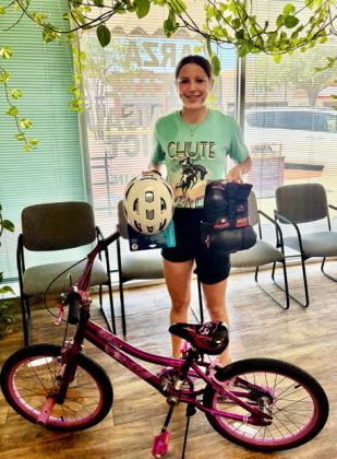 SUMMER SURPRISE Leightyn Reiter selected as the girls’ winner of a new bicycle at the Fourth of July Bicycle drawing sponsored by Post Community Recovery Center. | COURTESY PHOTO