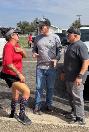 FIRST AID Sheriff Michael Isbell and EMT first responder Rodney Tidwell offered aid to riders as they passed through Post. Tidwell was heard asking if there was any first aid, blisters, bandages, drinks that were needed for participants.