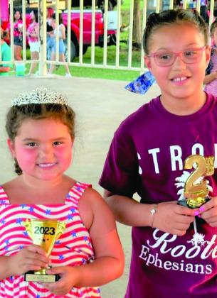 Miss Aubreigh DeLaCruz proudly wears her crown as the winner of Miss Firecracker 6-8. Annabella Graves took home the second-place trophy.