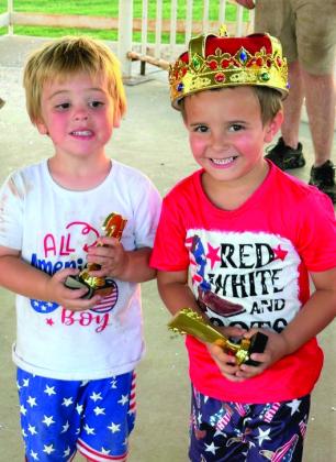 Remington Odom holds his second-place trophy, while Braxton Garcia dons the crown of Mr. Firecracker in the 3-5 age category.
