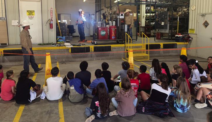ELECTRICITY Don’t get close to the powerlines! The class looks on with amazement to see that electricity can “jump” from the lines even if they are not touching it. | ANNA GIBSON PHOTO