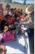 EQUIPMENT The children learn the tools of the electrical lineman trade. Without most of these tools, the lineman will have a“shocking” experience. | ANNA GIBSON PHOTO