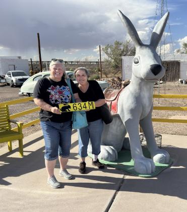 HERE WE ARE Kay and Barbara with our own sign to remind us the distance from back home to the Jack Rabbit. | COURTESY PHOTO