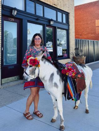 BIRTHDAY DONKEY Whitney Dorsett was surprised with a party for her 40th birthday by her husband and the help of her friends. Together they bought Senior Carrots. Courtney Howard decorated and made the flower crown for the donkey and Lacy Beck brought the donkey to town. Michele Liston was accommodating to allow Senior Carrots into the Winehouse! | COURTNEY HOWARD PHOTO