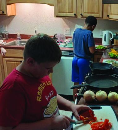 4-H FOOD PREP Philemon Gibson and EJ Webb are shown slicing bell peppers during their cooking challenge class on Monday, September 30. | PHOTO PROVIDED
