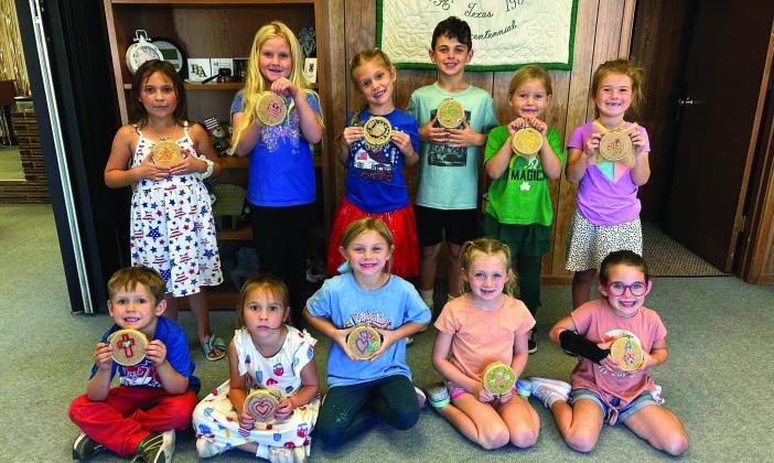 4-H EMBROIDERY Clover Kids and a few third-grade siblings did such a great job learning to embroider, Thursday, September 26. They were taught a simple back stitch with a plastic needle and yarn on burlap. They drew their own picture and picked their colors. Back row: Eva Jo Grizzell, Sara Tadlock, Zoee Ray, Samuel Reiter, Samantah Tadlock, and Kennedy Beck. Front: Raleigh Ray, Eliza Grizzell, Cameryn Clements, Maevery Mason, and Ava Reiter. | XANE REITER PHOTO