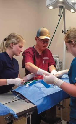 SHOP TALK Vet students Alyssa Otto and Laural Bailey learned from Dr. Kerry Wink in the operating theater and in the eld. | COURTESY PHOTOS