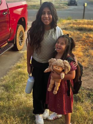 Sisters Kinley and Khole Gomez are ready to get to school, but they must stop for mom Kim to take the first-day school photo. Kinley is a sixth grader and Khole will started second grade. | COURTESY PHOTO