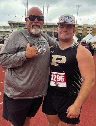 SILVER MEDALIST Athletic Director and shot put coach John Wright shares a proud moment with his son, Mason Wright, after Mason earned the silver medal in shot put at the 2A StateTrack Meet in Austin and breaking a fifty-seven-year-old school record school record.