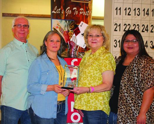 Business of the Year - Brady’s Package Store. Standing left to right are Gregg Tidmore, Cha’la Cimental, Wendy Tidmore, and Antonia Rivera.