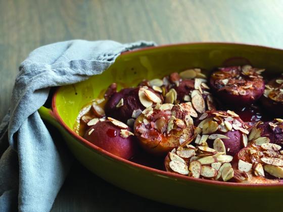 SWEET AND DELICIOUS Roasted plums with almonds make for a delightful and simple dessert or snack. This dish can be enjoyed warm, perhaps with a dollop of mascarpone or yogurt for a creamy contrast. | ANGELINA LARUE PHOTO