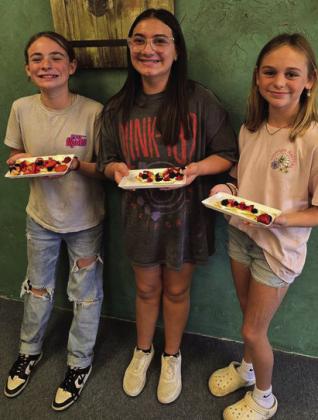 GIRLS COOKING Monday, October 15, the 4-H intermediate food challenge team members Daveigh, Elliot, and Cenci made fruit pizza crackers. They are working hard to prepare for the competition in November. | XANE REITER PHOTO