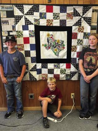 QUILTING Friday, October 11, Kye, Rein, and Connor completed the top of the quilt for the GCJLA Homemaking division. Raffle tickets will go on sale soon. | XANE RIETER PHOTO