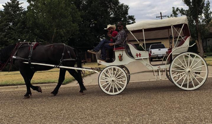 RIDE THROUGH You never know what you'll see on Main Street. Cody Marshall and Reece Belongia took a trip through town on July 20 in the Cross H carriage. | ANNA GIBSON