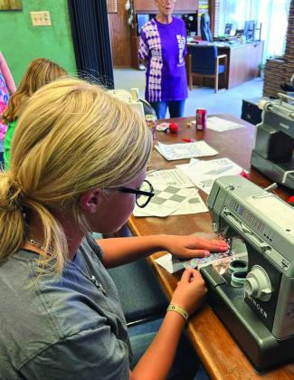 QUILT FOR RAFFLE The Garza County 4-H sewing club members Trinity Arocha, Bella Hayek, Rein Howard, and Kye Baker are working hard at sewing a Texas themed quilt to raffle for the Garza County Junior Livestock Association Homemaking Division. Tickets will go on sale November 1. | XANE REITER PHOTOS