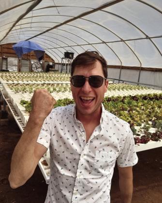 Cory Root in new greenhouse just set up with hydroponics system. Courtesy Photo