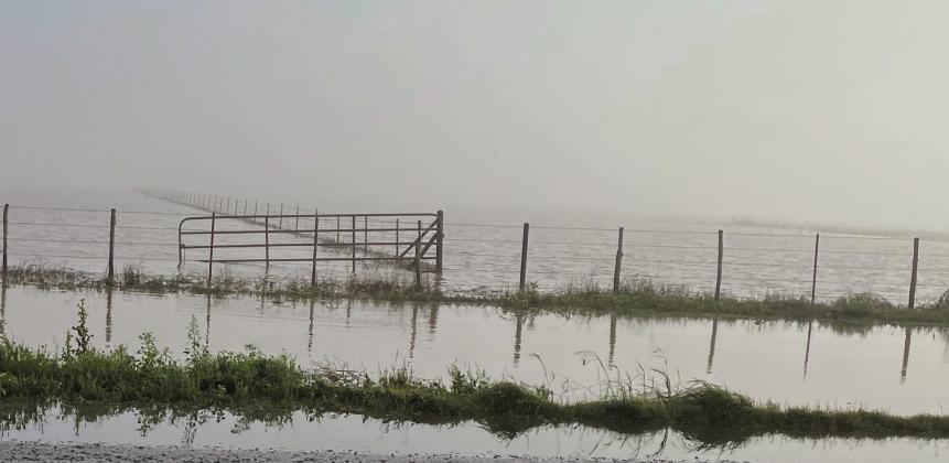 A typical scene on Friday morning after the downpour the previous day. Early morning fog, payla lake overflowing onto US 380. Photo Provided