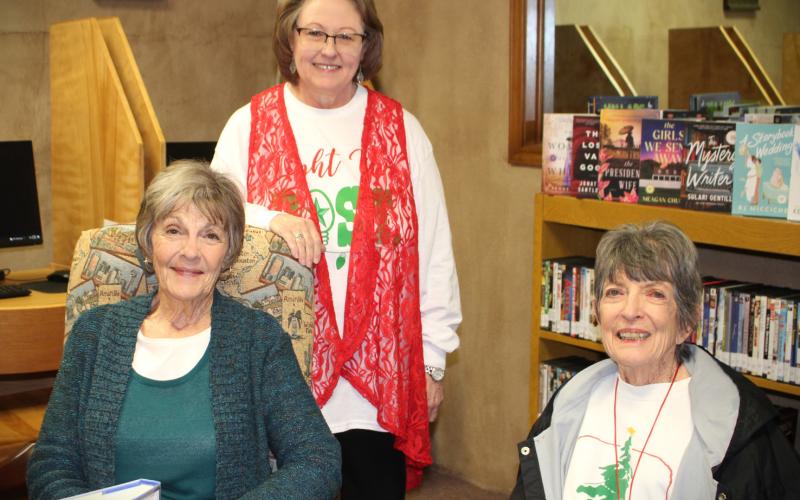 OPEN HOUSE Post Public Library hosted a Christmas Open House last Thurs. Dec. 14. Librarian Pam Humble served hot cider and cookies to avid readers Beth Cook and Carolyn Black. The library will be closed today through Dec. 26. Pam reminds everyone to come in next week, Dec. 27 through Dec. 29 and check out the new books selections. | JULIA CHILDS PHOTO