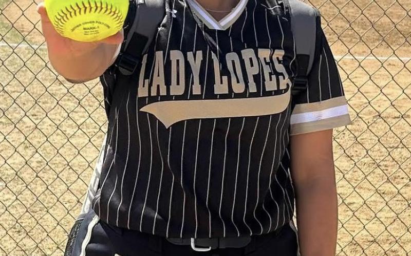 Post Lady Lope Zailey Perez poses with the game ball after hitting her first home run of the season during the Lady Lopes’ district game against New Home. | COURTESY PHOTO