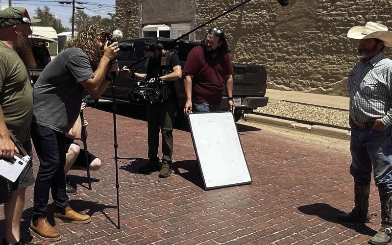 FILM CREW - Calina Mishay, mural artist, and her film crew were in the Post last week to capture scenes around town and interview people for her new TV series called Cal’s Hometown Revival. Jeff Williams is shown talking about the mural painted downtown and the significance the mural paintings have had on Post. Cal’s Hometown Revival will air on Destination America by Discovery starting October 1. More information as the date gets closer. | STAFF PHOTO