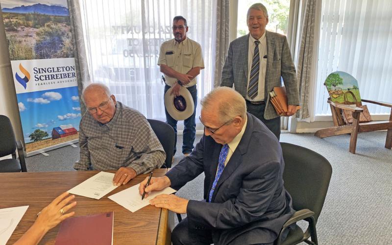 CLOSING OF SALE Curtis Hudman, president of the Public Facilities Corporation, and County Judge Lee Norman signed the sale closing paperwork of the Giles W. Dalby Correctional Facility to the State of Texas Oct. 14. | STAFF PHOTO
