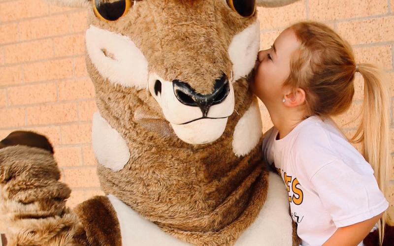 Oscar is gearing up for the 2023 Football Season. Kennedy Beck, a mini-cheerleader, is definitely in love with Oscar. They will be on the field cheering on the Bold Gold Antelopes in an upcoming game. | WHITNEY DORSETT PHOTO