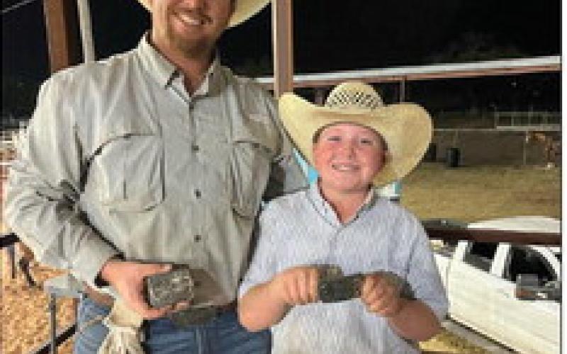 OPEN ROPING Kasen Williams (11) and Carter Roberson hold their buckle prizes after the big win in the Open Roping. In addition, Williams won the Junior Breakaway. | COURTESY PHOTO
