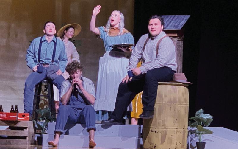 THEATERTROUPE UILOneActPlayTheDivinersisperformedbythe PHS students. Ferris Layman played by Branson Harris sits with C.C. Showers played by Jonah Pequeno and Buddy Layman played by MaxximusColeforarefreshingdrinkattheDine-Away-Cafeowned by Goldie Short played by Maddie Hart. | POST DISPATCH PHOTO