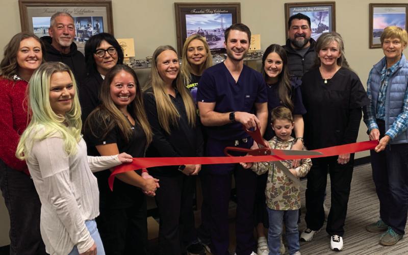 POST EYECARE Tuesday, November 19, Dr. Garrett Wentz cut the ribbon to the newly opened Post Eyecare located at the Garza County Healthcare District. In support are Traci Jarrett, Jacey Cathey, Randy Conner, Christina Jones, Dr. Xochitl Anderson, Brandy Fannon, Janie Suber, Dr. Garrett Wentz with his wife Kara and son Graham, Chita Hattaway, Jamie Hernandez, and JoAnn Travis. | ANNA GIBSON PHOTO
