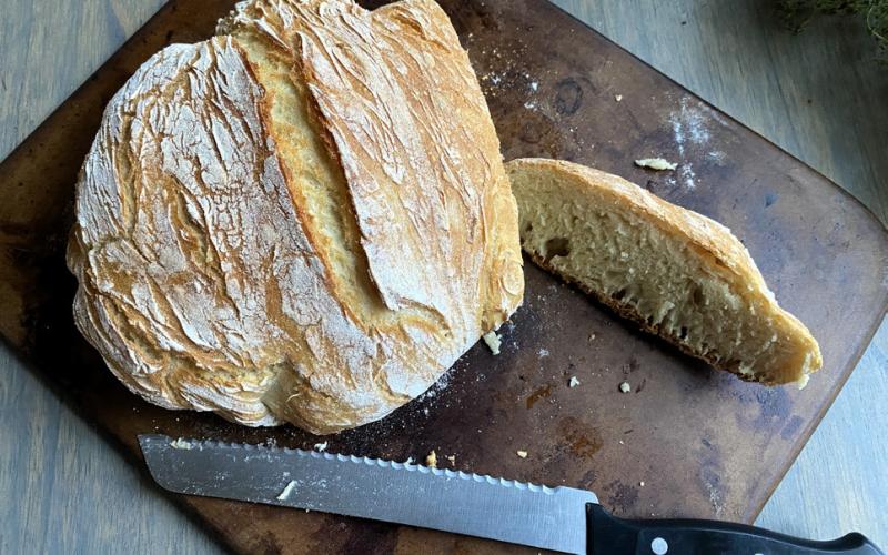 DUTCH OVEN BREAD This recipe is simple yet yields bakeryquality results with just flour, yeast, sugar, salt and water. Using a no-knead method and minimal rise time, the bread is ready in about three hours. The preheated Dutch oven creates a soft interior and crisp crust, making it a versatile and rewarding option for both beginners and experienced bakers. | ANGELINA LaRUE PHOTO