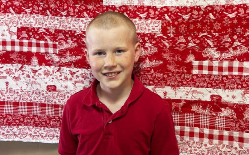 NEXT GENERATION Connor Griffen, 10, shows off his “Christmas Jelly Roll Race” quilt entry during the May 2 Garza County Quilt Show. | COURTESY PHOTO