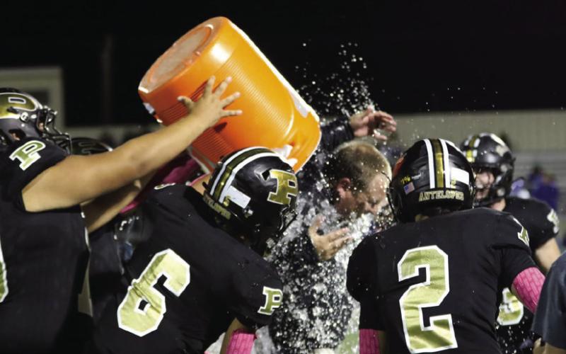 Coach Hayden Patterson gets the celebratory dousing after the win over Tahoka.