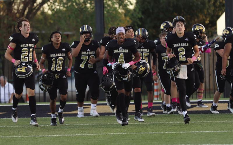 Cruz Navarro leads the team to the sidelines after the team huddle!