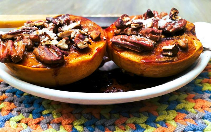 BAKED PEACH topped with cinnamon, pecans and maple syrup makes a cozy, wholesome fall treat. Easy to prepare and full of flavor, it offers a lighter alternative to pie that feels just as indulgent.| ANGELINA LARUE PHOTO