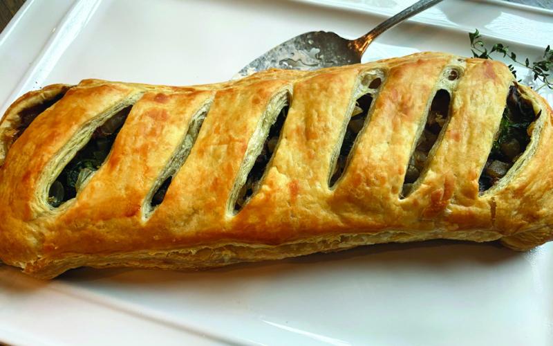 MUSHROOM WELLINGTON is a culinary delight you won’t want to miss! This dish beautifully combines earthy, rich mushrooms with a flaky, golden pastry that envelops a rich filling, creating a comforting yet sophisticated dining experience. | ANGELINA LARUE PHOTO