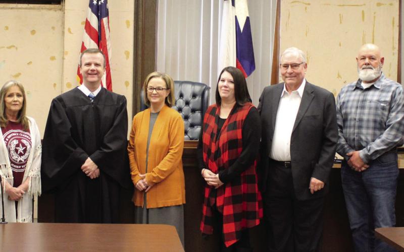 District Judge Reed Filley held swearing-in ceremonies for Garza County’s newly elected officials on Sunday afternoon, Jan. 1. Standing left to right are Giles Dalby, Jr., Terri Laurence, Filley, LuAnne Terry, Angela Massey, Lee Norman, Gordon Terry, and Kim Wilks. Photo by Julia Childs