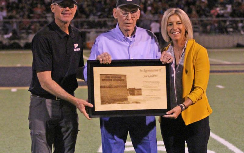 HONORARY TITLE Joe Giddens (center) was honored by Post ISD during the homecoming game, Sept. 19. After 28 years of serving the Post school district, the board of trustees voted in February 2025 to name the field house the Joe Giddens Sports Complex. | RYLAN MORRIS PHOTO