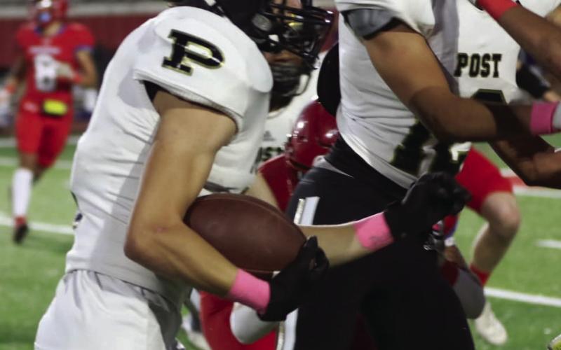 Senior Cory Mason blocks for Cruz Navarro, who carries the ball for a total of 111 yards in Week 9 game against Sundown.