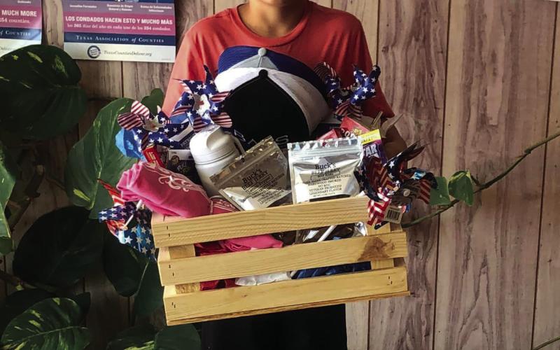 IMPRESSIVE DISPLAY Legend Odom is presented with a gift basket for receiving the Best Entry award from July 4 parades’overall float. | DAWN GRAVES PHOTO