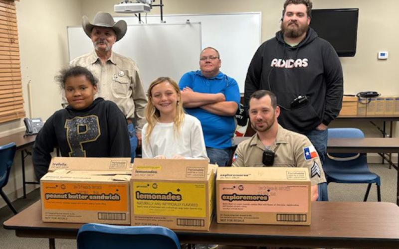 BIG THANK YOU Dezariyah Spann and Averie Howell gave Girl Scout cookies to Garza County Sheriff Michael Isbell, Chief Deputy Travis Johnson, Dispatcher Jayden Carroll and Patrol Sgt. Sean Thornton in appreciation of their service. | COURTESY PHOTO