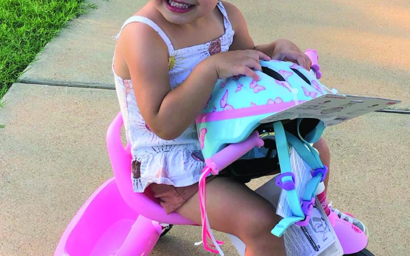 Chole Davis won a new tricycle from the Community Recovery Center for the best-decorated entry in the Bike Parade held on July 4.