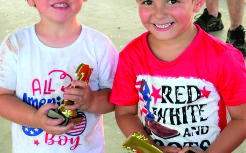 Remington Odom holds his second-place trophy, while Braxton Garcia dons the crown of Mr. Firecracker in the 3-5 age category.