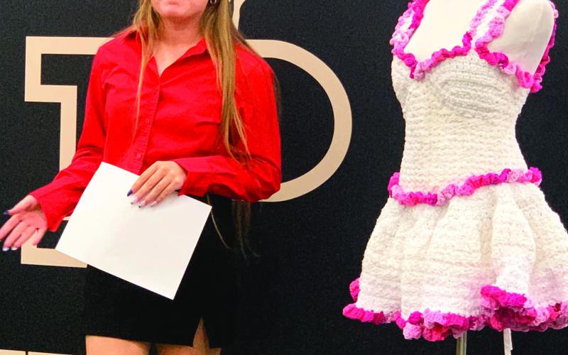 SHABBYTO CHIC Addisyn Gray gave a special presentation during the school board meeting, Monday, April 7, about her crocheted project that she entered at the Regional Repurpose and Redesign FCCLA. Gray said the project took 25 hours, three king-sized sheets cut into one-inch strips, and a few t-shirts. Gray was inspired by her grandmother who taught her how to crochet. | ANNA GIBSON PHOTO