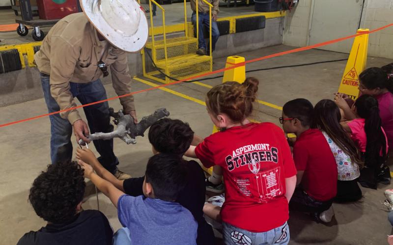 ARTIFACT With much confusion, the class learns that what they hold is not wood, but rather glass. They have learned that when electricity from the lines touches the ground it causes the sand to melt from the extreme heat, making glass. | ANNA GIBSON PHOTO